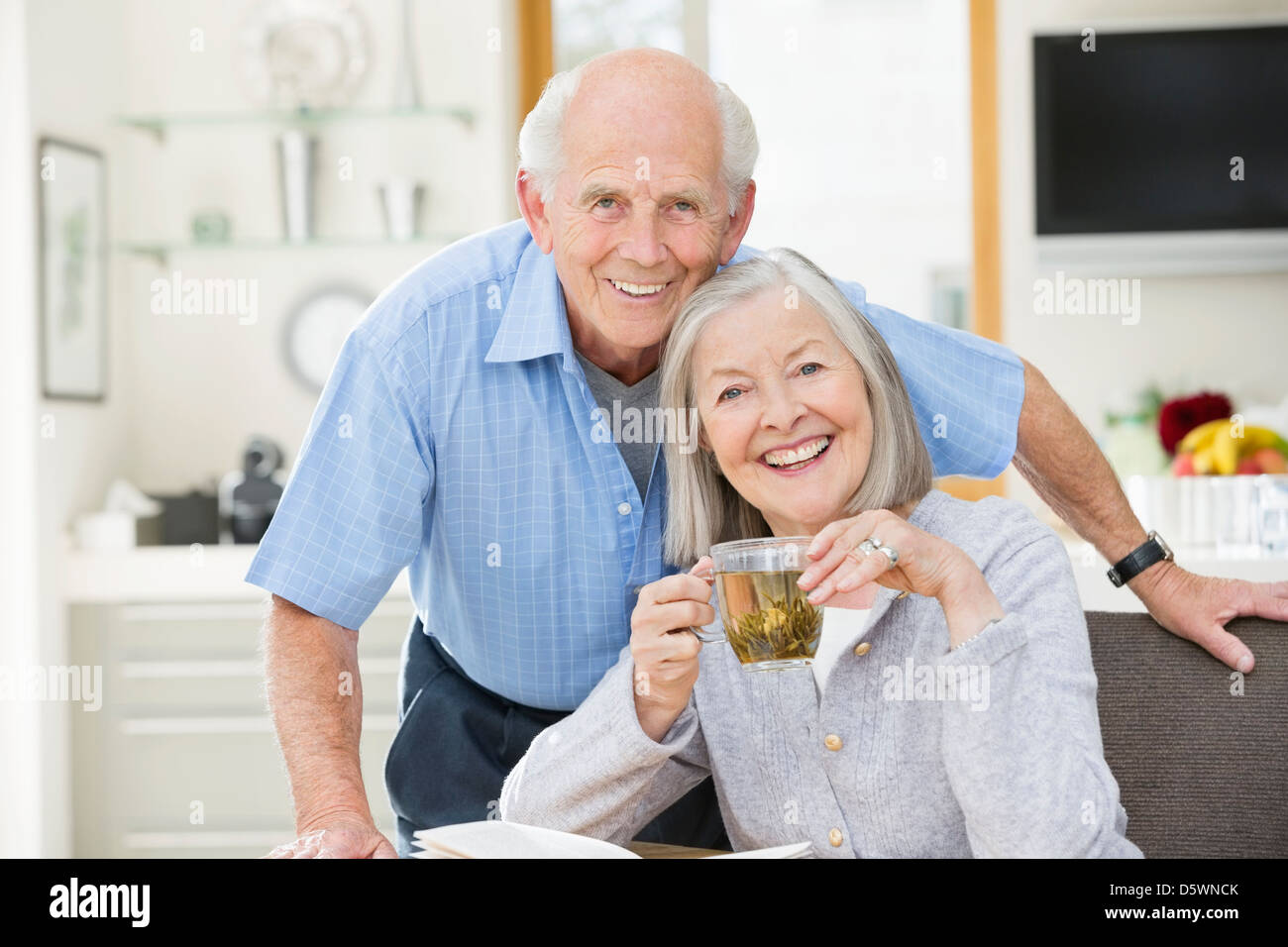 Anziana coppia sorridente in cucina Foto Stock