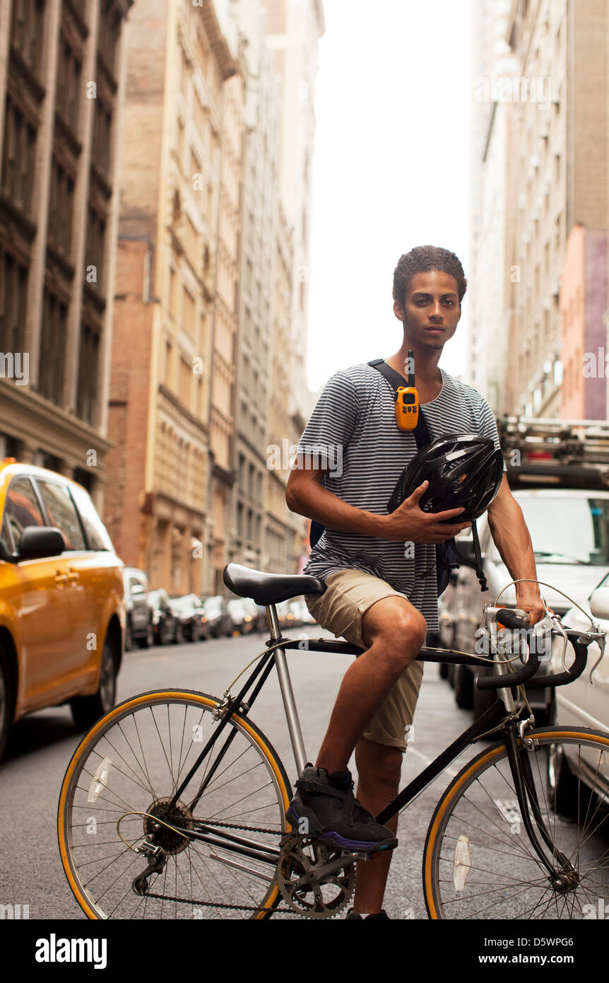 Uomo in bicicletta sulla strada di città Foto Stock