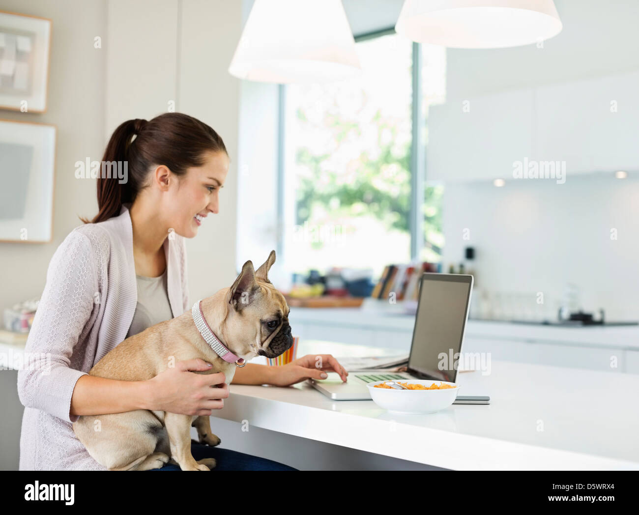 Donna con notebook con il cane in giro Foto Stock