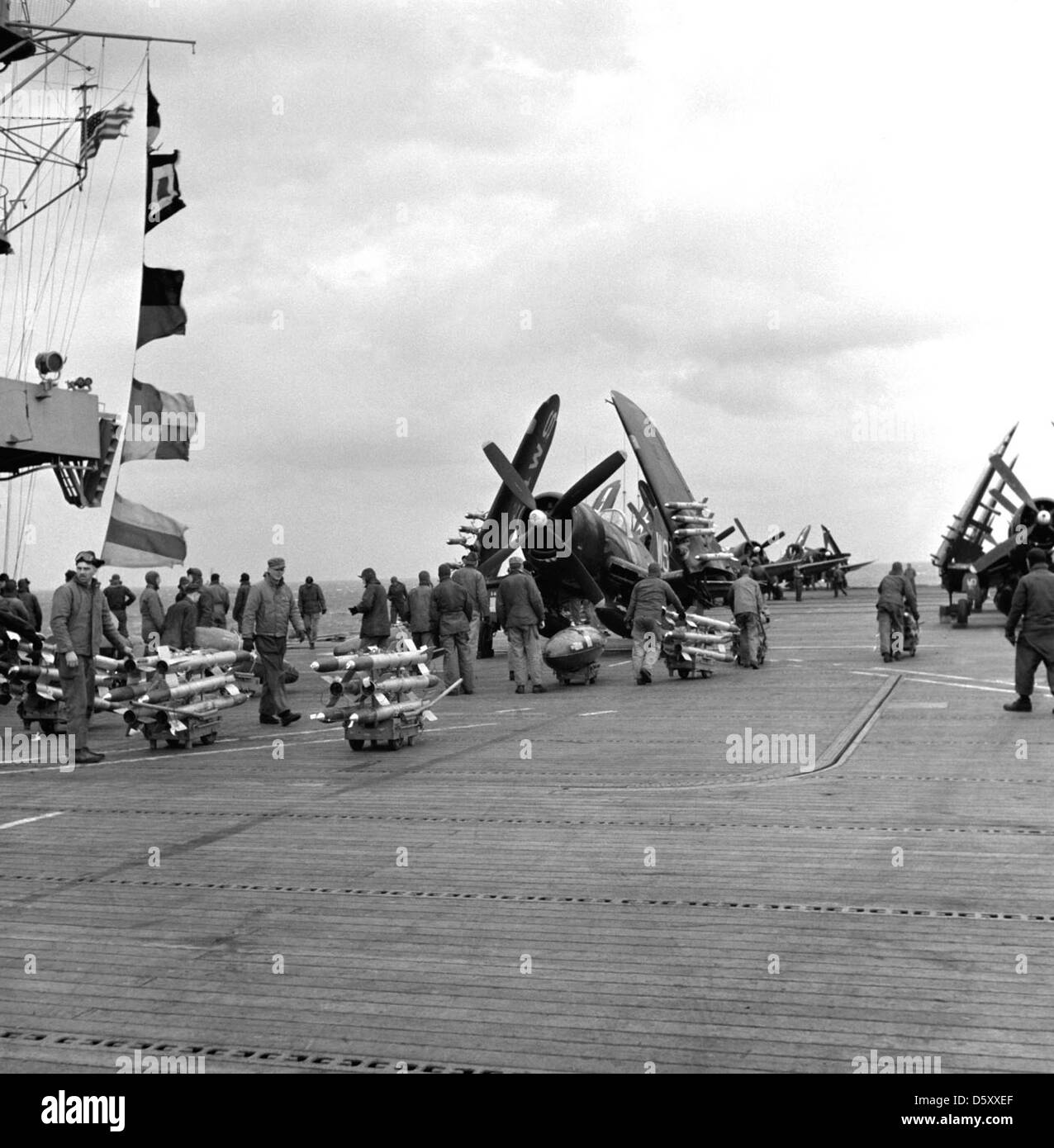 Gli equipaggi USMC preparano velivoli Vought F4U-4B Corsair con razzi da 5 pollici e contenitori napalm a bordo della USS Badoeng Strait (CVE-116), durante le operazioni al largo della costa coreana nel 1950. Il Corsair fu un aereo cruciale durante la guerra di Corea. Foto Stock