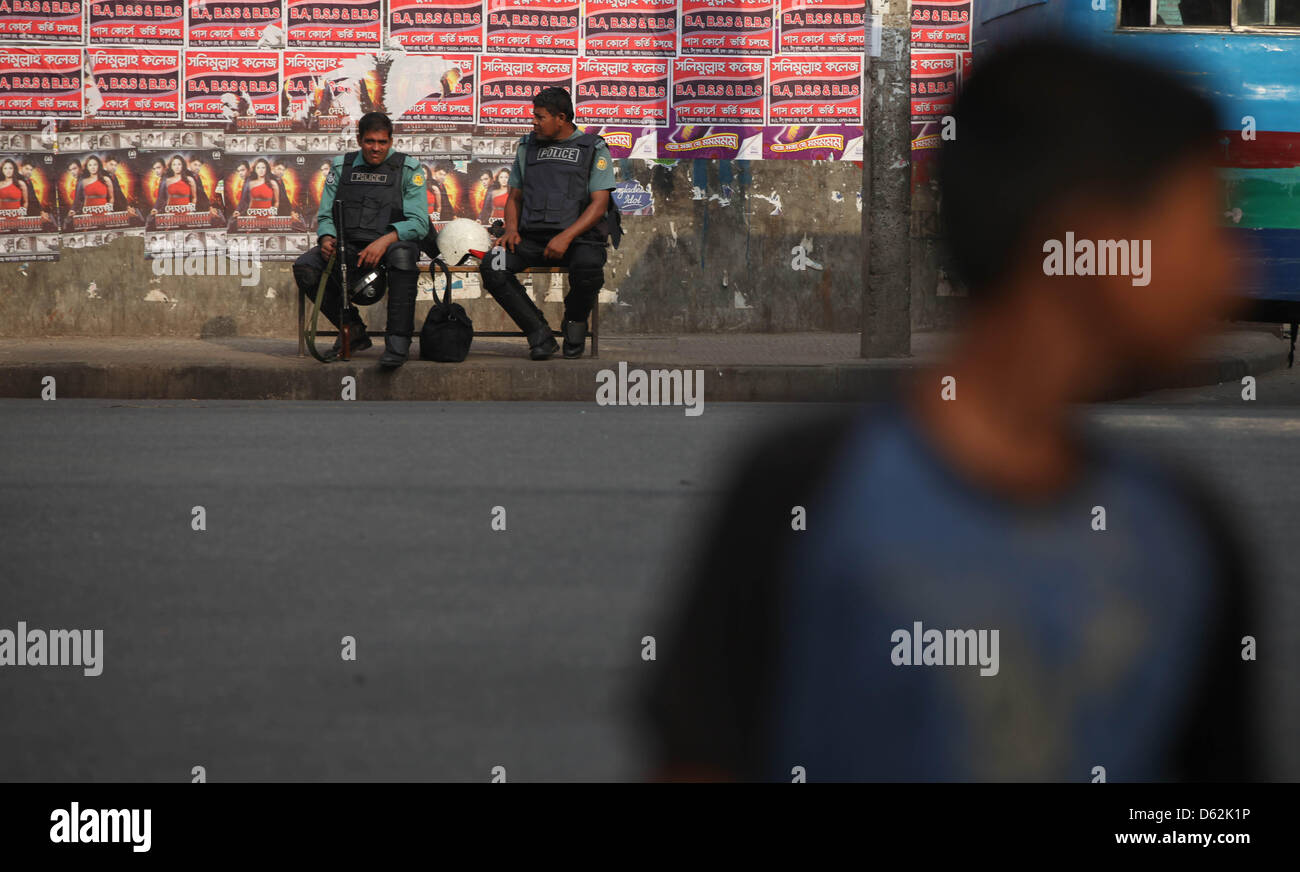 Aprile 11, 2013 - Dhaka, Bangladesh - una polizia del Bangladesh sedersi sulla panchina a piedi sulla strada durante la nationwide strike chiamato dall opposizione gruppo Jamaat-e-Islam€™s ala studentesca Islami Chhatra Shibir applicate fino al crepuscolo sciopero nazionale nella vecchia Dhaka on April 11, 2013. Il Islami Chhatra Shibir applicate un giù al crepuscolo sciopero generale in tutto il paese principalmente per chiedere il rilascio dei loro leader e attivisti detenuti. Â©Monirul Alam (credito Immagine: © Monirul Alam/ZUMAPRESS.com) Foto Stock