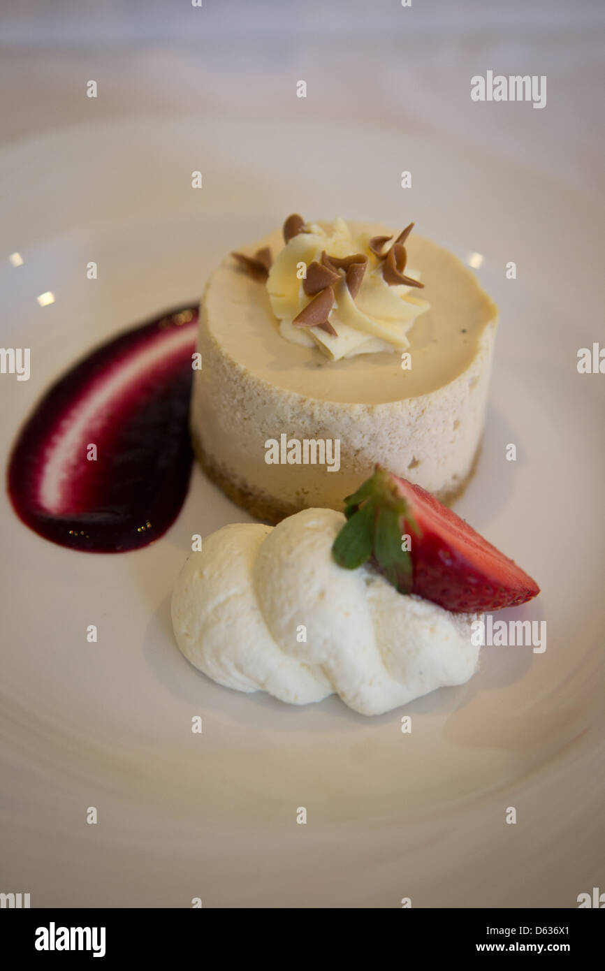 Toffee e Fudge Cheesecake con coulis di ribes nero Foto Stock