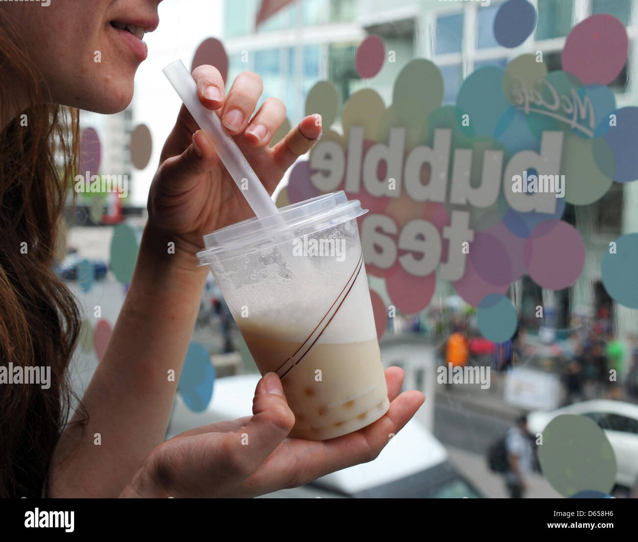 Una giovane donna di bevande di tè di bolle in corrispondenza di una McCafe a Berlino (Germania), 12 giugno 2012. McDonald's ha introdotto la bevanda alla moda, le esperienze che un crescente aumento di popolarità in Germania, nella sua McCafes il 11 giugno 2012. Foto: Jens Kalaene Foto Stock