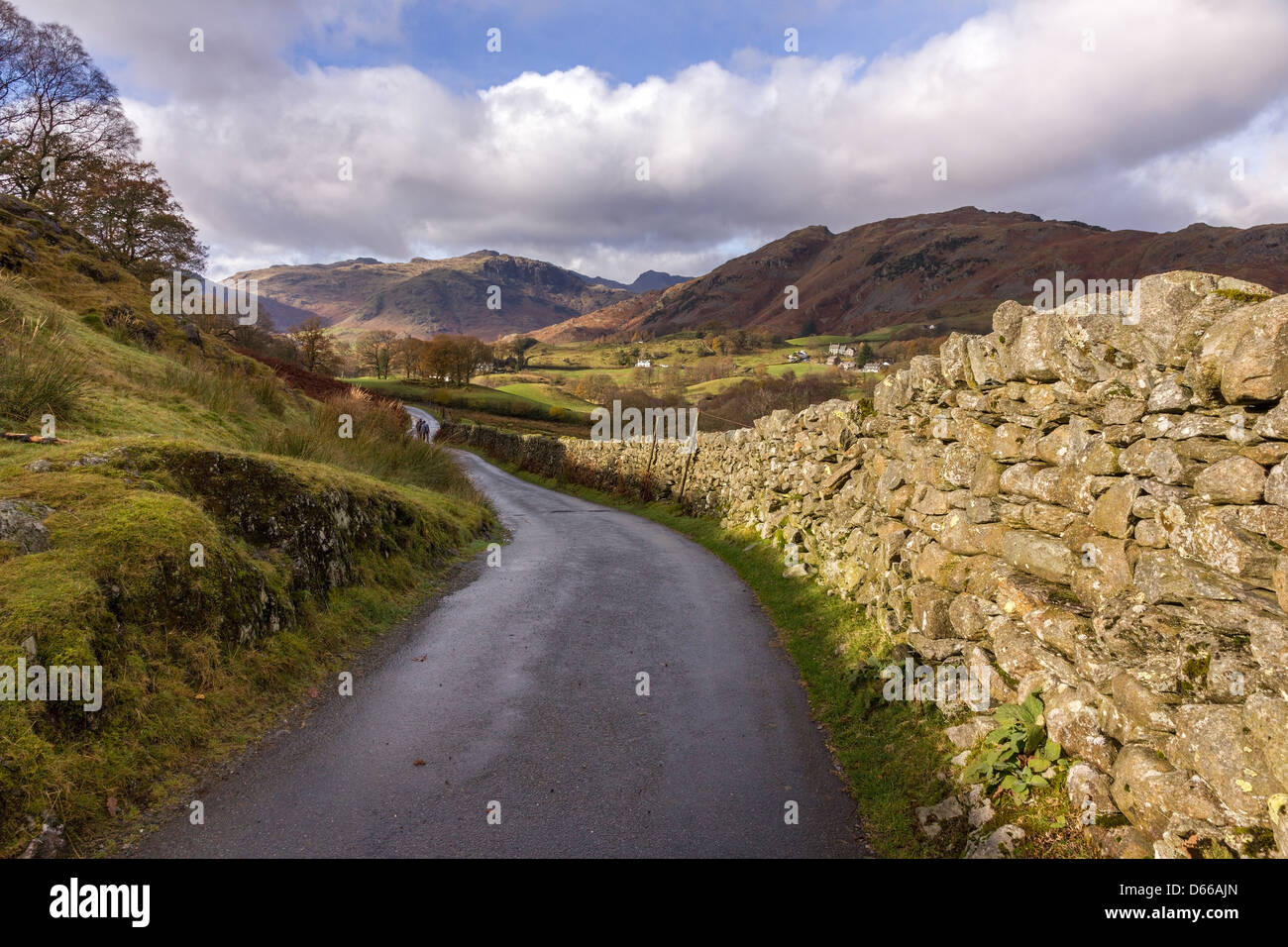 Strada di campagna a Little Langdale con pareti a secco e montagne oltre, Lake District, Cumbria, Inghilterra, Regno Unito Foto Stock