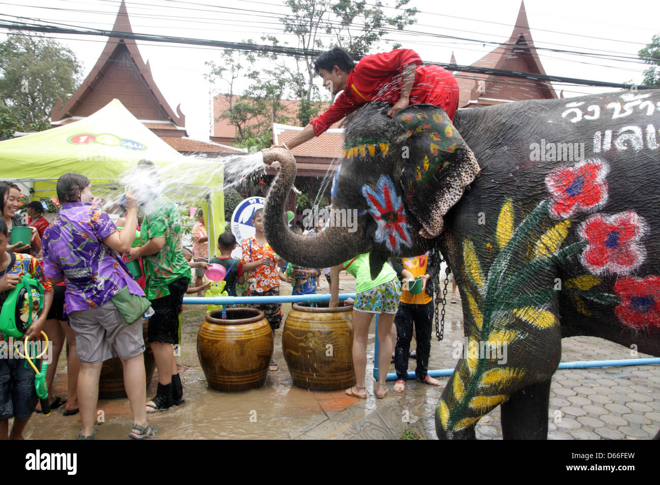 Ayutthaya, Thailandia. Il 13 aprile 2013. I turisti stranieri sono spruzzate durante una battaglia di acqua con un elefante. Songkran, Thailandia del nuovo anno festival inizia segnando l inizio del nuovo anno per le popolazioni Thai dal 13 al 16 aprile , quando le persone celebrare in vari modi, compresi gli spruzzi di acqua in corrispondenza di ogni altro per fortuna. Credito: Piti un Sahakorn/Alamy Live News Foto Stock