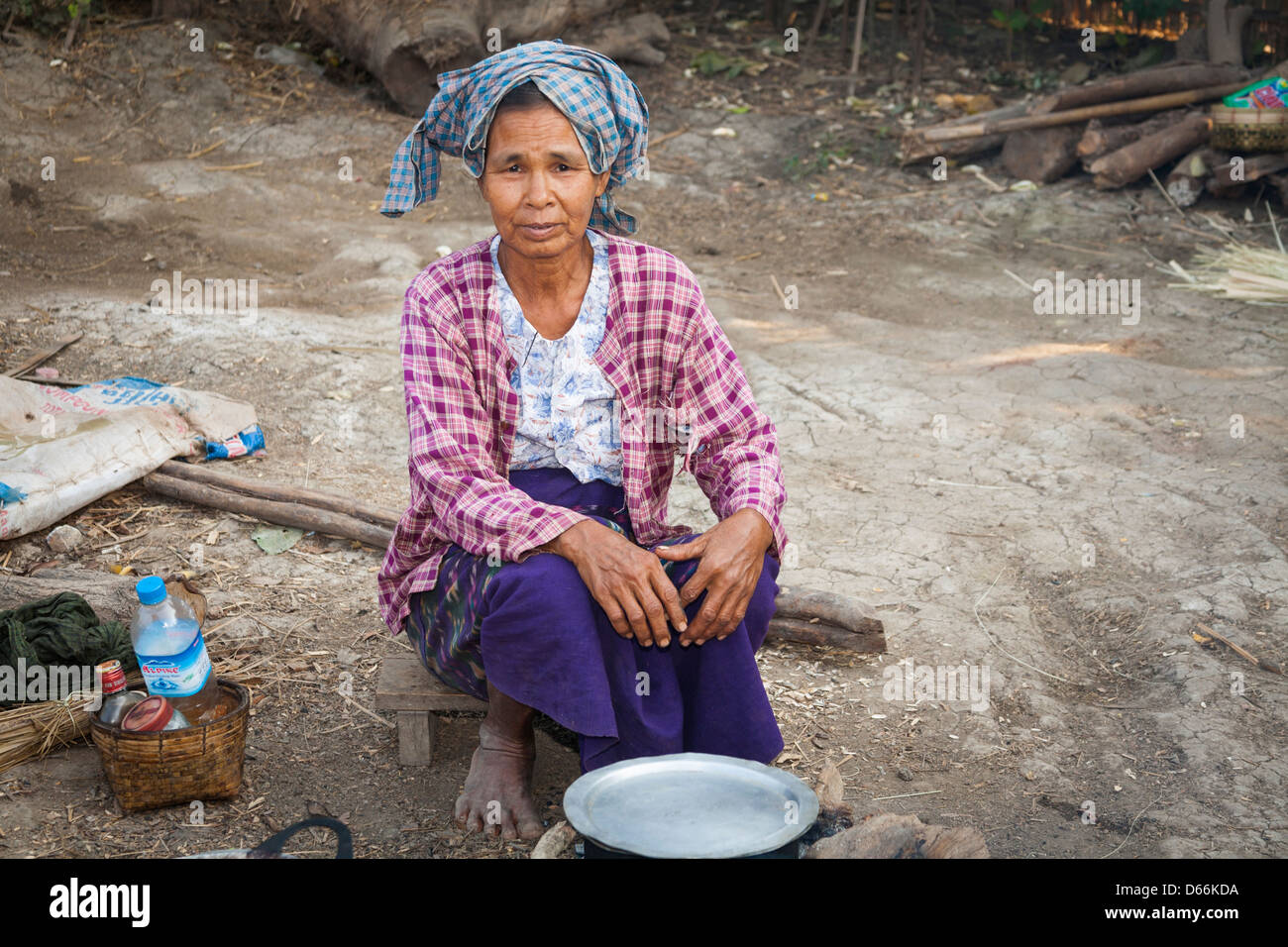 Donna anziana cucinando fuori, Yay Kyi village, Mandalay Myanmar (Birmania) Foto Stock