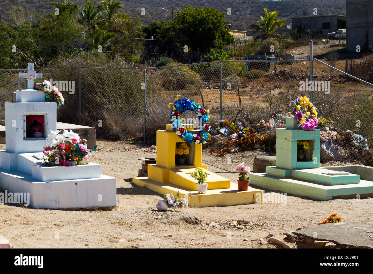 Colorate pietre di testa mark tombe decorate con fiori di imitazione in un cimitero di Todos Santos, Messico. Foto Stock