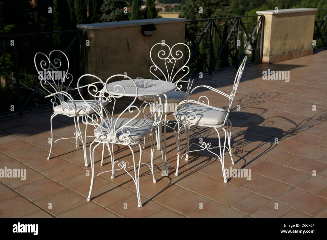 Ornano il filo bianco sedie in un bar tavola in Siena Italia Foto Stock