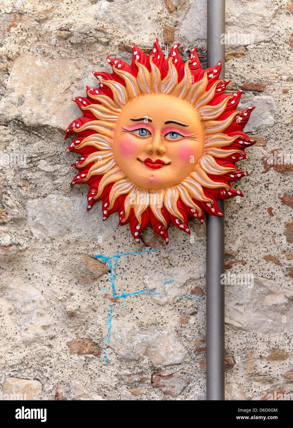 Una parete in ceramica lapide raffigurante un sorridente sun Foto Stock