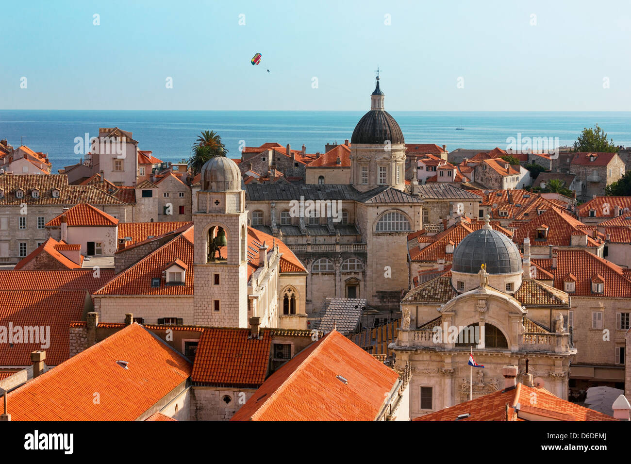Città vista della cattedrale e del mare sui tetti di vecchi edifici. Paracadute colorato è passante. Foto Stock