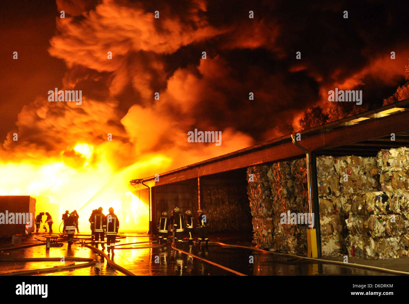 Vigili del fuoco provare a spegnere un incendio in un materiale recxcling fadcility in Grambek, Germania, 11 settembre 2012. Un incendio scoppiato nella notte dal 11 al 12 settembre 2012. Un portavoce del dipartimento di estinzione ha detto che il fuoco coperto un'area pari ad un campo di calcio. La causa dell'incendio resta sconosciuta al momento. Foto: Nimtz cristiana Foto Stock