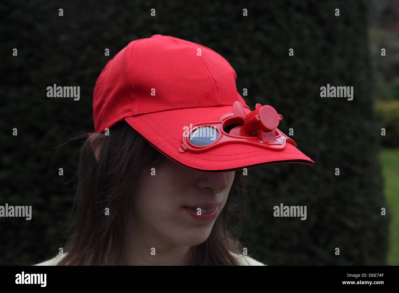 Donna che indossa Red Berretto da baseball con energia solare ventilatore  Foto stock - Alamy