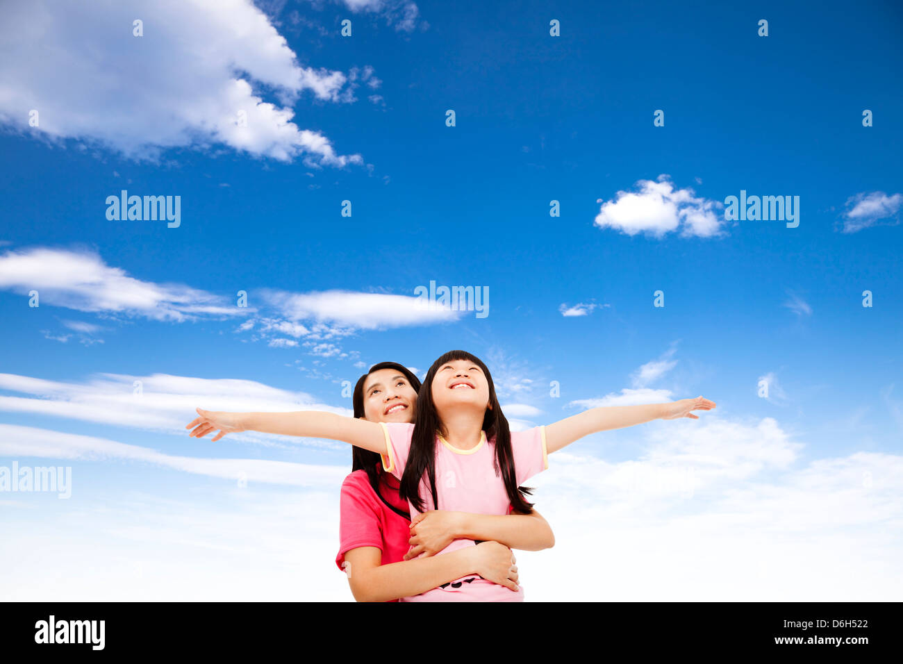 Felice bambina e madre guardando il cielo Foto Stock