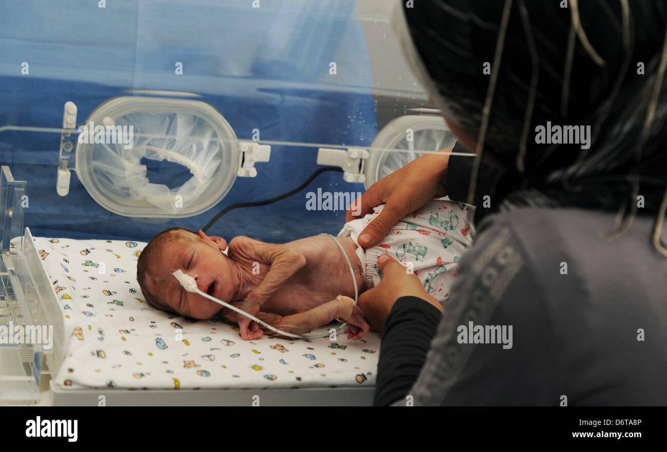 Darkoush, Siria. Xxi Aprile, 2013. Baby Mohammed Al Khalaf presso il dono dell'ospedale o un infermiere on April 22, 2013, in Darkoush, Siria. Il bambino è nato a 30 settimane e dovette fuggire l'ospedale dove era nata con la sua madre quando il governo siriano ha attaccato la città. Durante gli ultimi 8 giorni, 45 South African personale medico hanno fornito assistenza medica a 4000 siriani. La loro missione volge al termine alla fine di aprile 2013. (Foto di Gallo Immagini / Foto24 / Felix Dlangamandla) Foto Stock