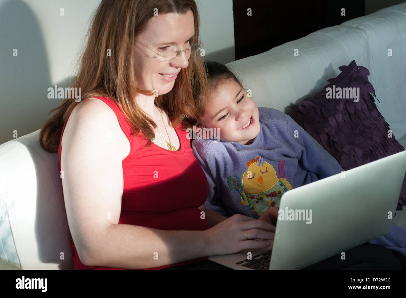La madre e il bambino con il computer portatile Foto Stock