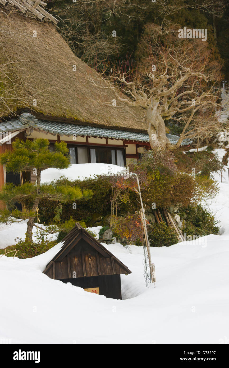 Tradizionale tetto in paglia casa in montagna coperta di neve, Miyama-cho, Prefettura di Kyoto, Giappone Foto Stock