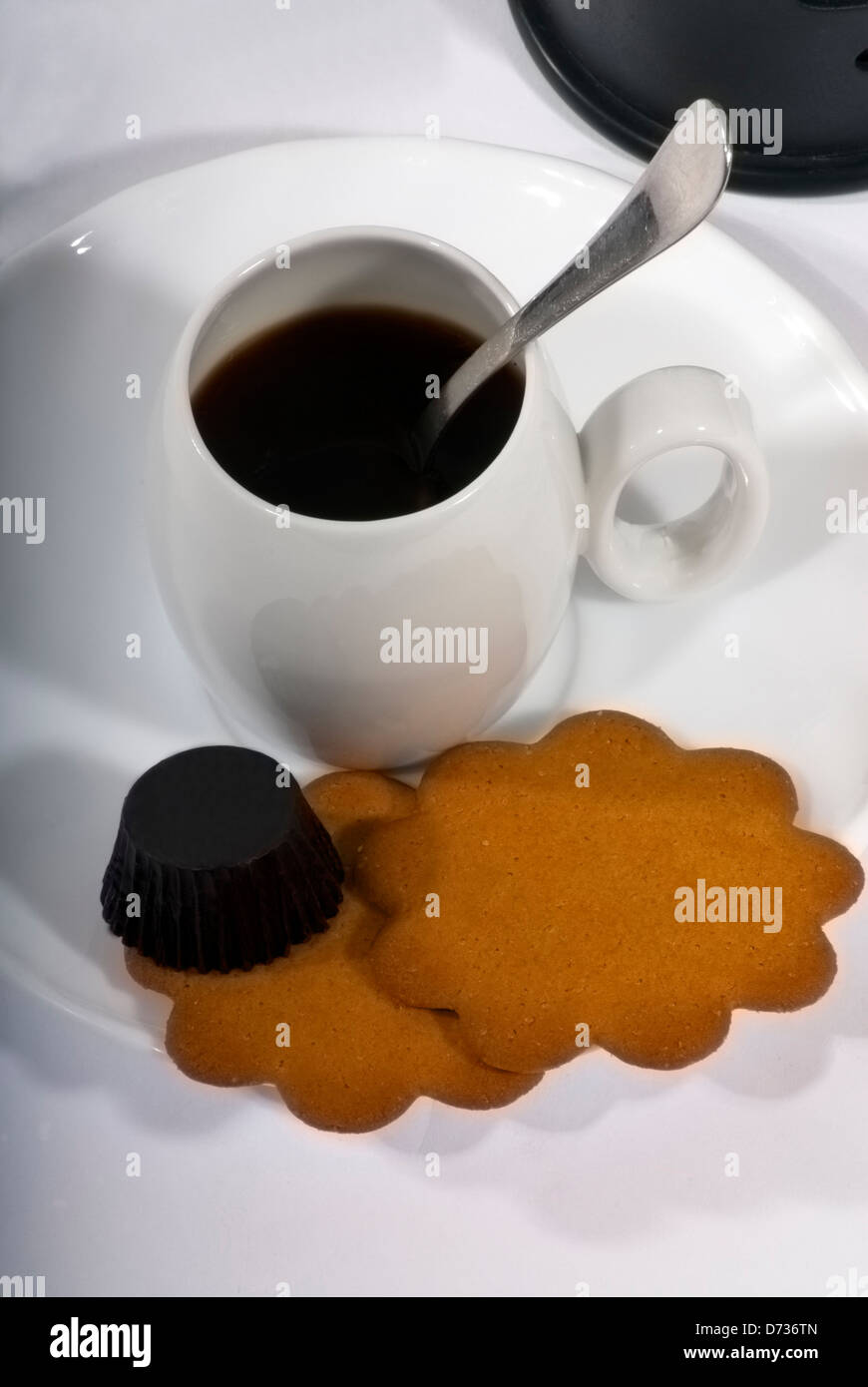 Caffè tradizionali, French press caffè e piccola tazza bianca con un cucchiaio d'argento, cioccolato e biscotti Foto Stock