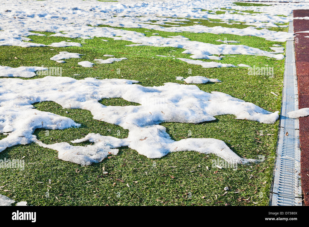 Cumuli di neve sul calcio all'aperto campo molla in bassa stagione Foto Stock