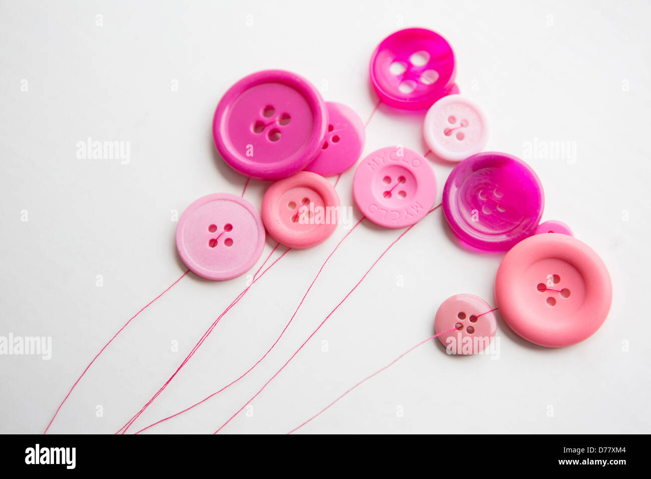 Pulsanti rosa filettato e posizionato in modo da apparire come palloncini Foto Stock