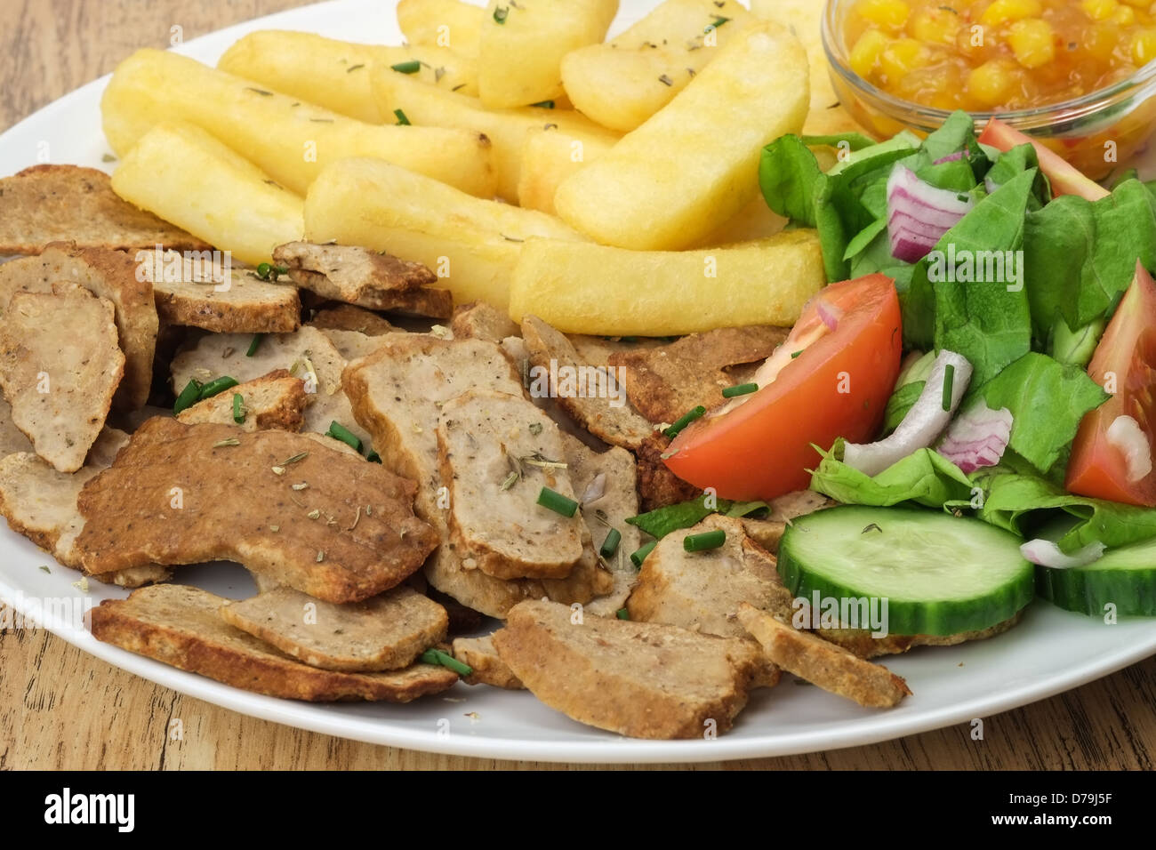 Fette di carne di manzo gyros o shawarma di carne con patate fritte e insalata mista Foto Stock