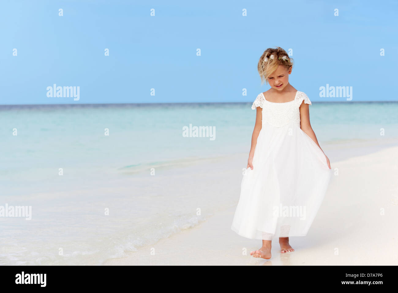 Giovane ragazza in damigella abito camminando sulla bellissima spiaggia Foto Stock