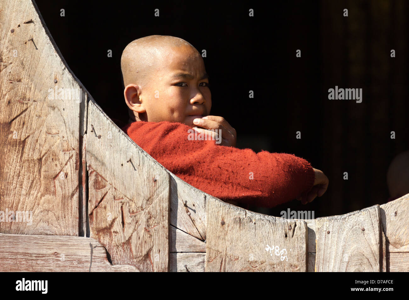 Un giovane monaco dalla finestra in Shwe Yaunghwe Kyaung monastero vicino Lago Inle, Myanmar 2 Foto Stock