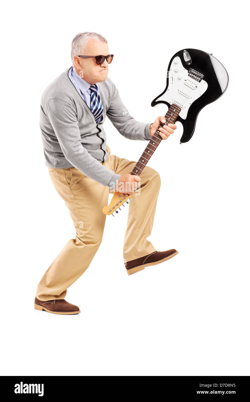 A piena lunghezza Ritratto di un arrabbiato uomo maturo rompendo una chitarra elettrica isolata su sfondo bianco Foto Stock
