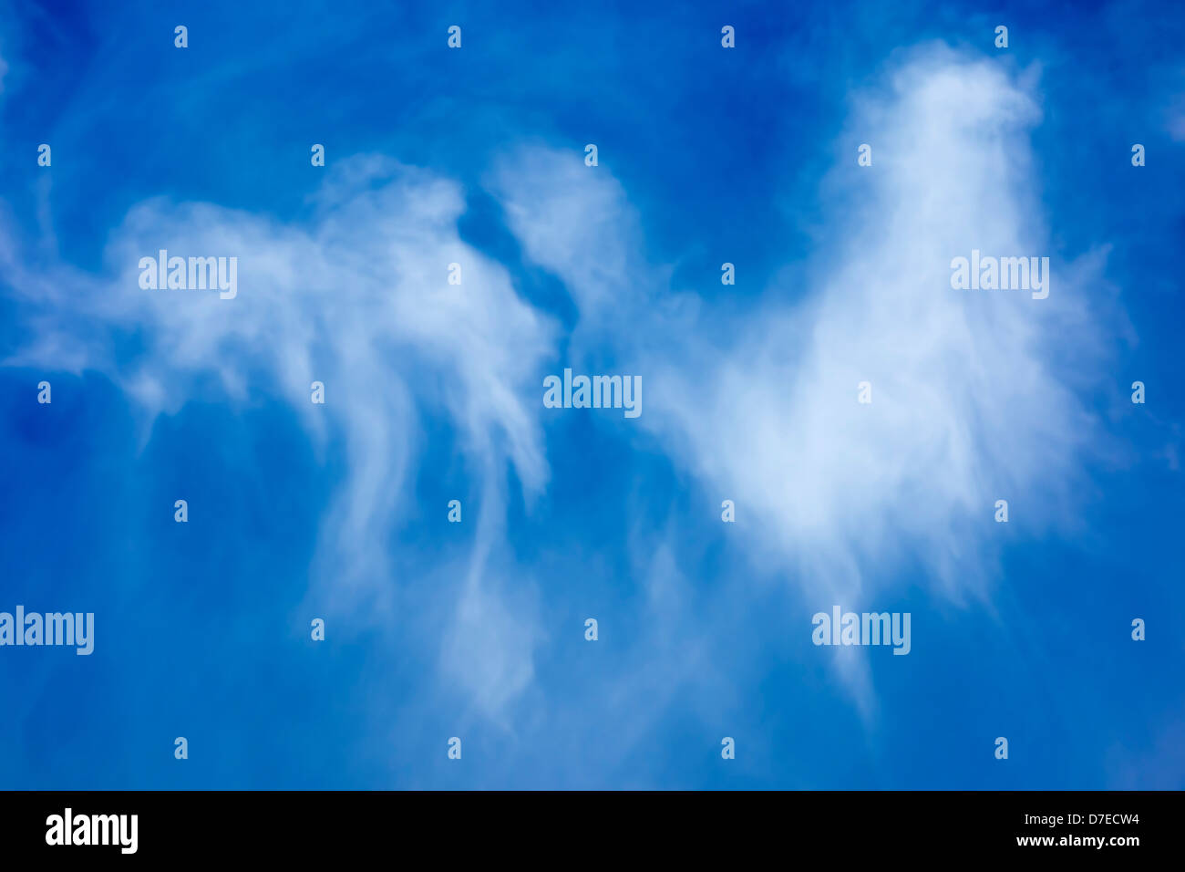 Wispy nuvole bianche contro il profondo blu del cielo Foto Stock