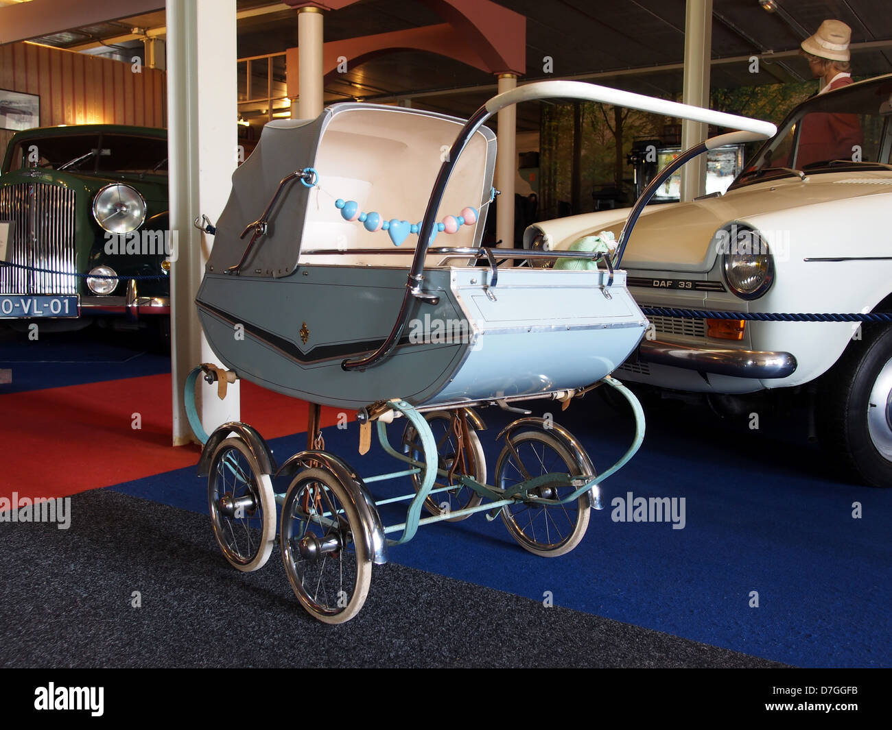 Questa immagine mostra un passeggino o una carrozza tradizionale, un elemento storico utilizzato per il trasporto dei bambini. La fotografia rappresenta la vita domestica e l'evoluzione dell'assistenza all'infanzia nei tempi passati. Foto Stock