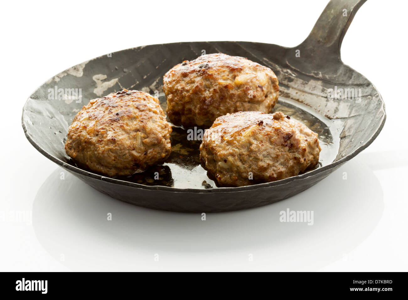 Fritte palline di carne in padella di ferro su sfondo bianco Foto Stock