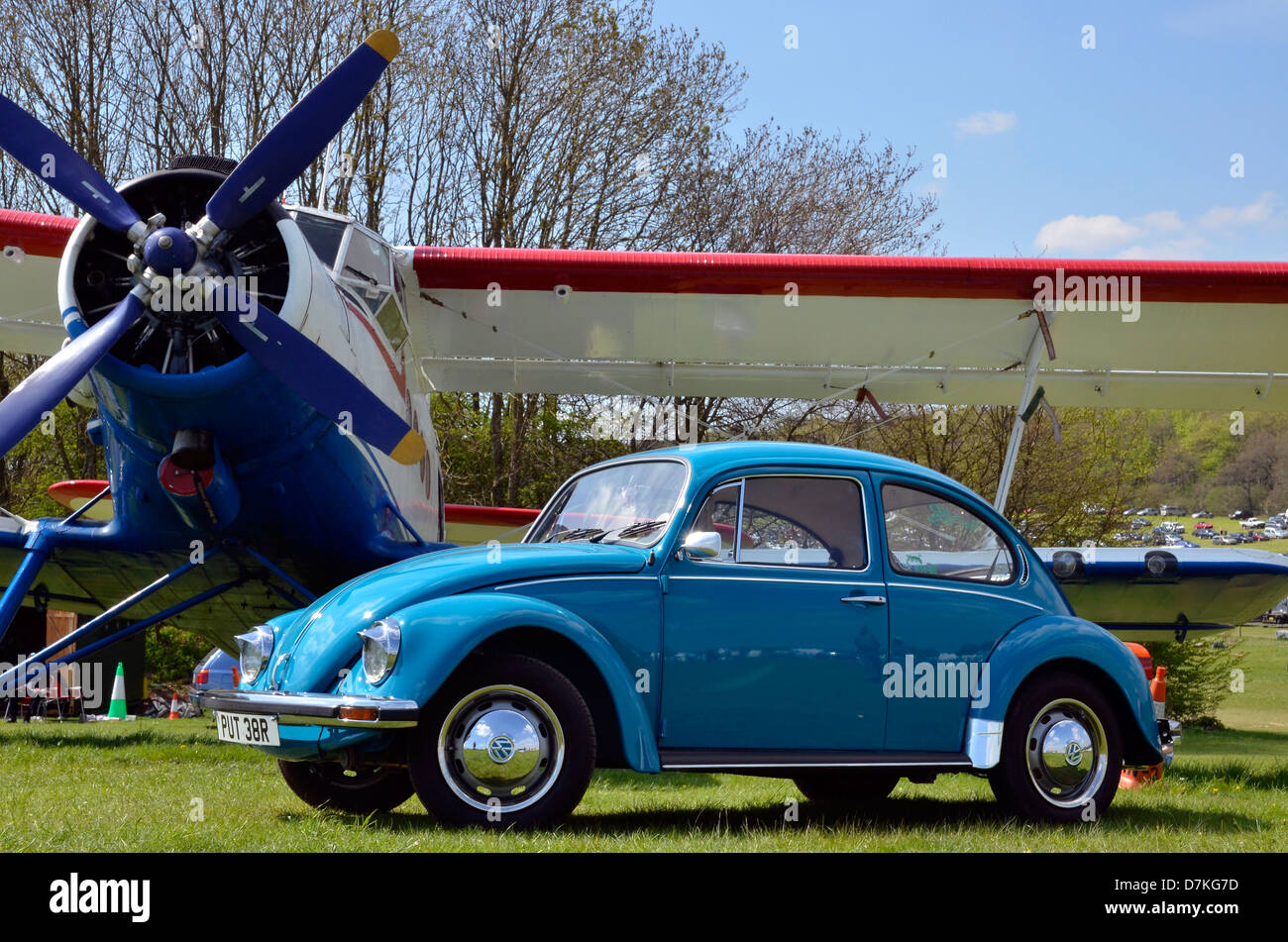 Classici dei primi anni sessanta Volkswagen maggiolino raffigurato nella parte anteriore di un Antonov un biplano-2. Foto Stock