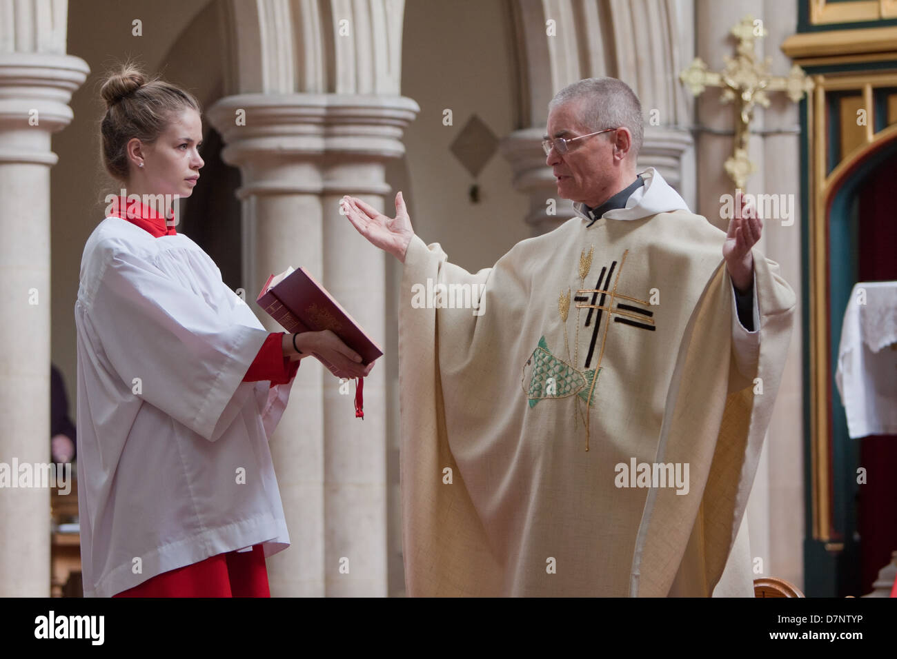Un prete cattolico legge il vangelo Foto Stock