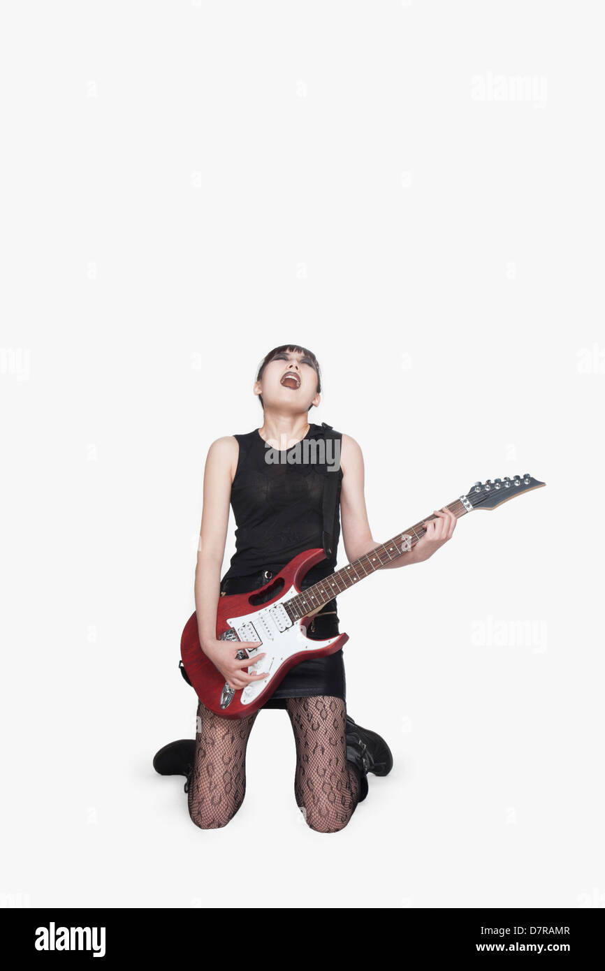 Punk Rocker inginocchiato con la chitarra Foto Stock
