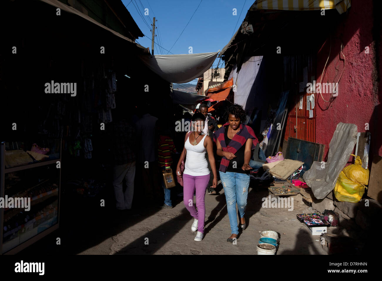 Due donne a piedi attraverso una strada del mercato ad Addis Abeba, Etiopia. Foto Stock