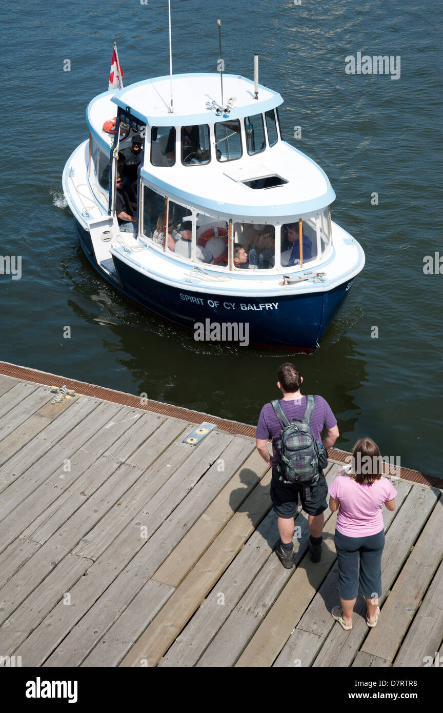 I passeggeri di attendere presso il dock a Granville Island come il Granville Island Ferry approcci, Vancouver, British Columbia, Canada Foto Stock