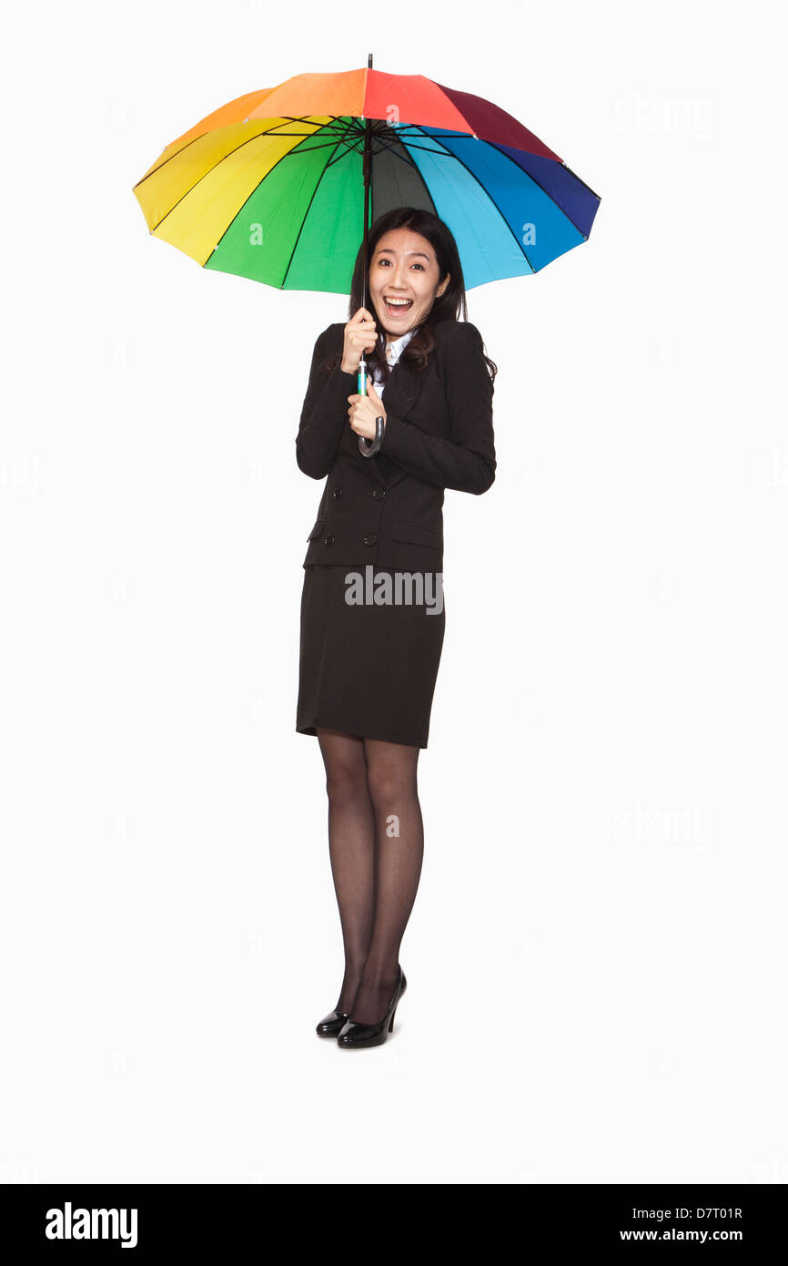 Imprenditrice sotto ombrello coloratissimo Foto Stock