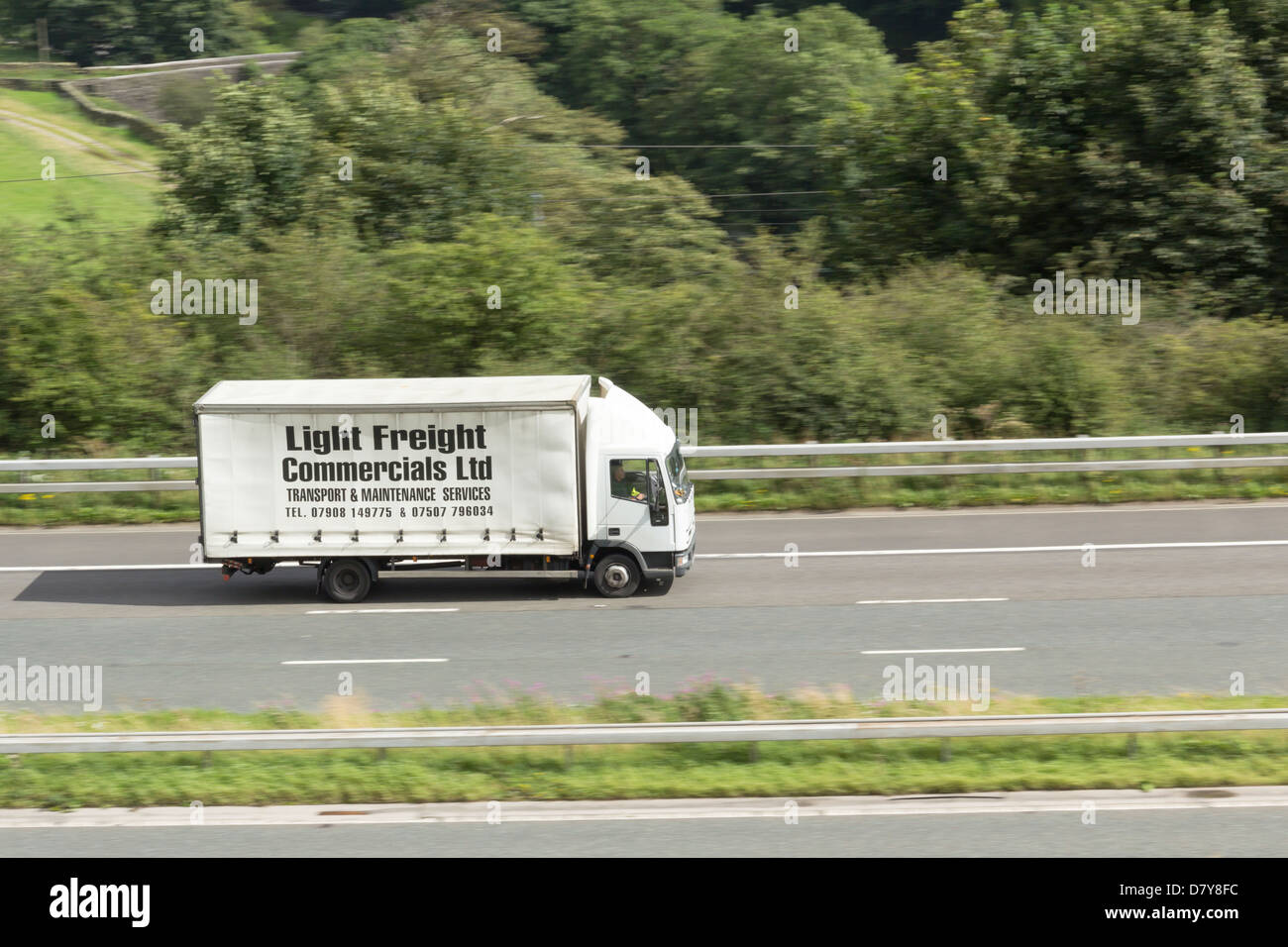 Luce spavento Commericals Ltd. tenda erogazione unilaterale autocarro voce verso sud sull'autostrada M6 nei pressi di Tebay , Cumbria Foto Stock