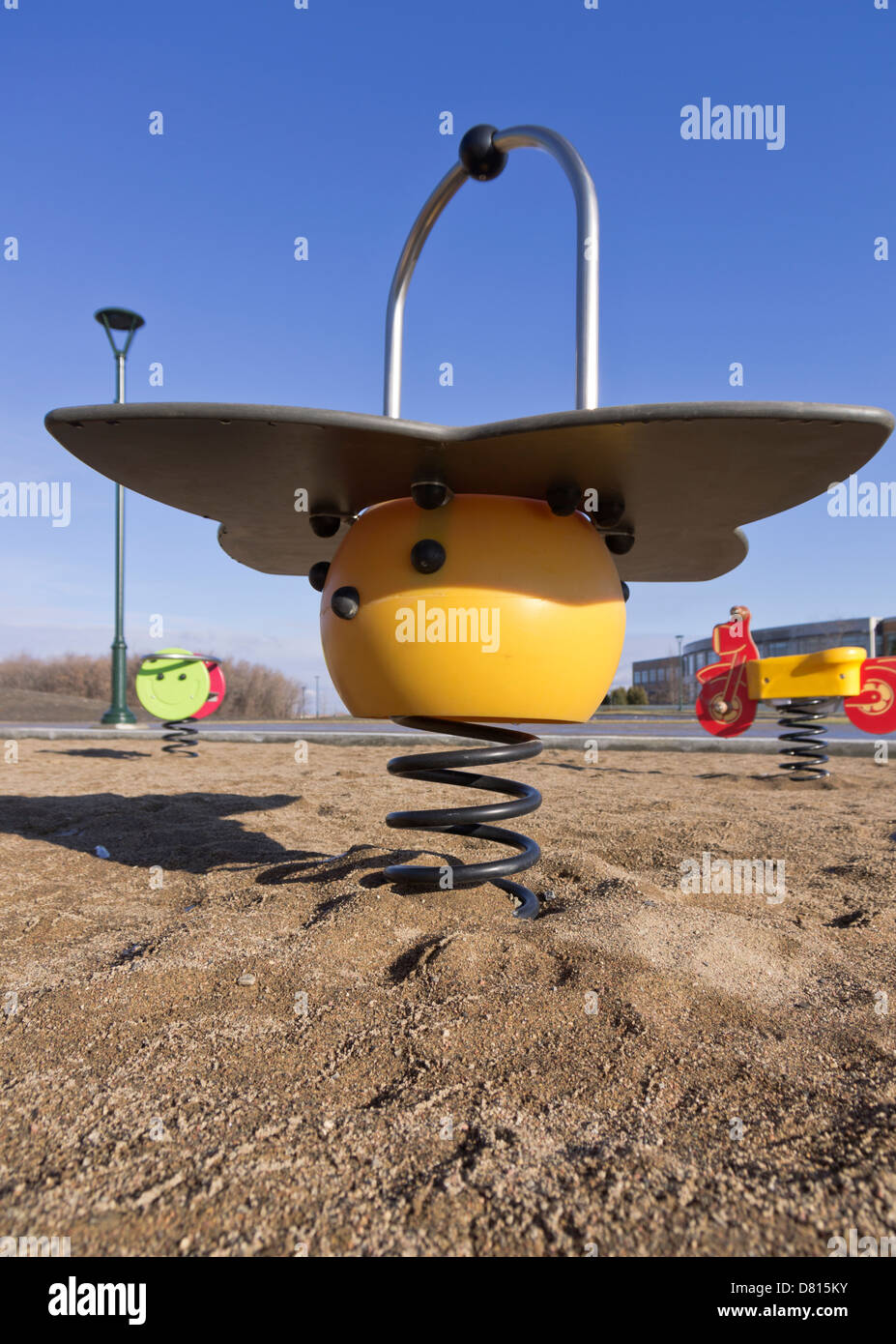 La molla piloti su un parco giochi in sabbia Foto Stock