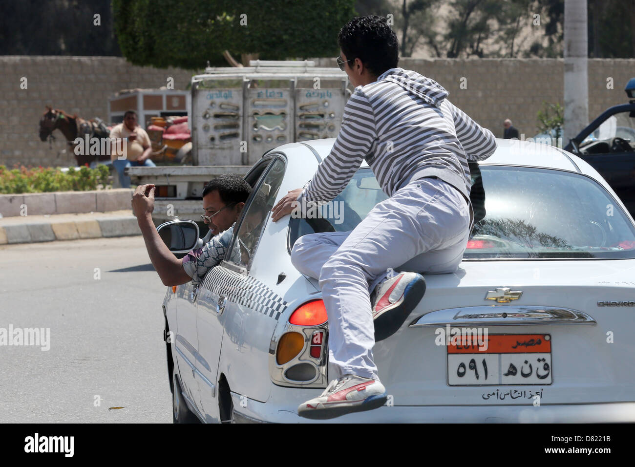 Il Cairo, El Giza. In modo non autorizzato chiamato guida turistica salta su un taxi con tourist, cerca di condurli in una trappola per turisti Foto Stock