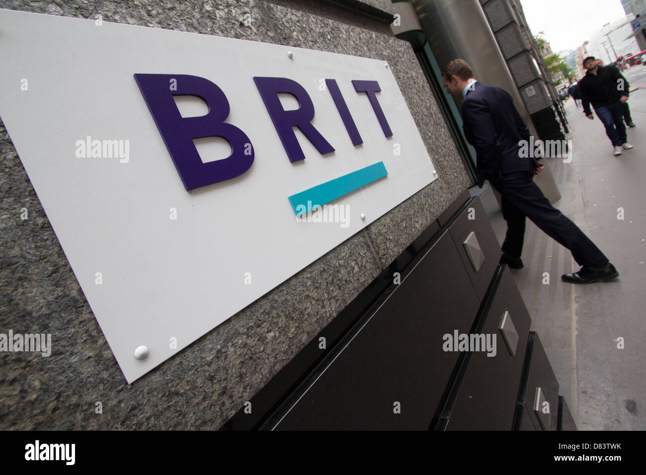 Un professionista del collare bianco entra nella sede centrale della Brit Insurance a Londra, rappresentando il fiorente settore assicurativo finanziario e commerciale della città, Londra, Regno Unito Foto Stock