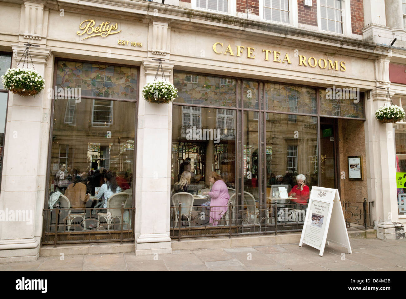 Sale da tè UK; persone che bevono nelle sale da tè Bettys cafe, St Helens Square Branch, York, Yorkshire UK Foto Stock