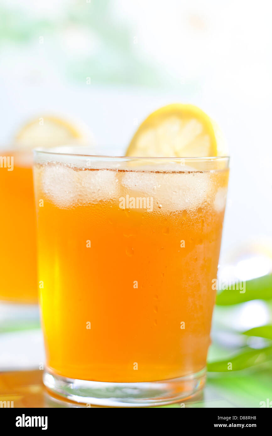 Bicchiere di tè freddo al limone su sfondo sfocato Foto Stock