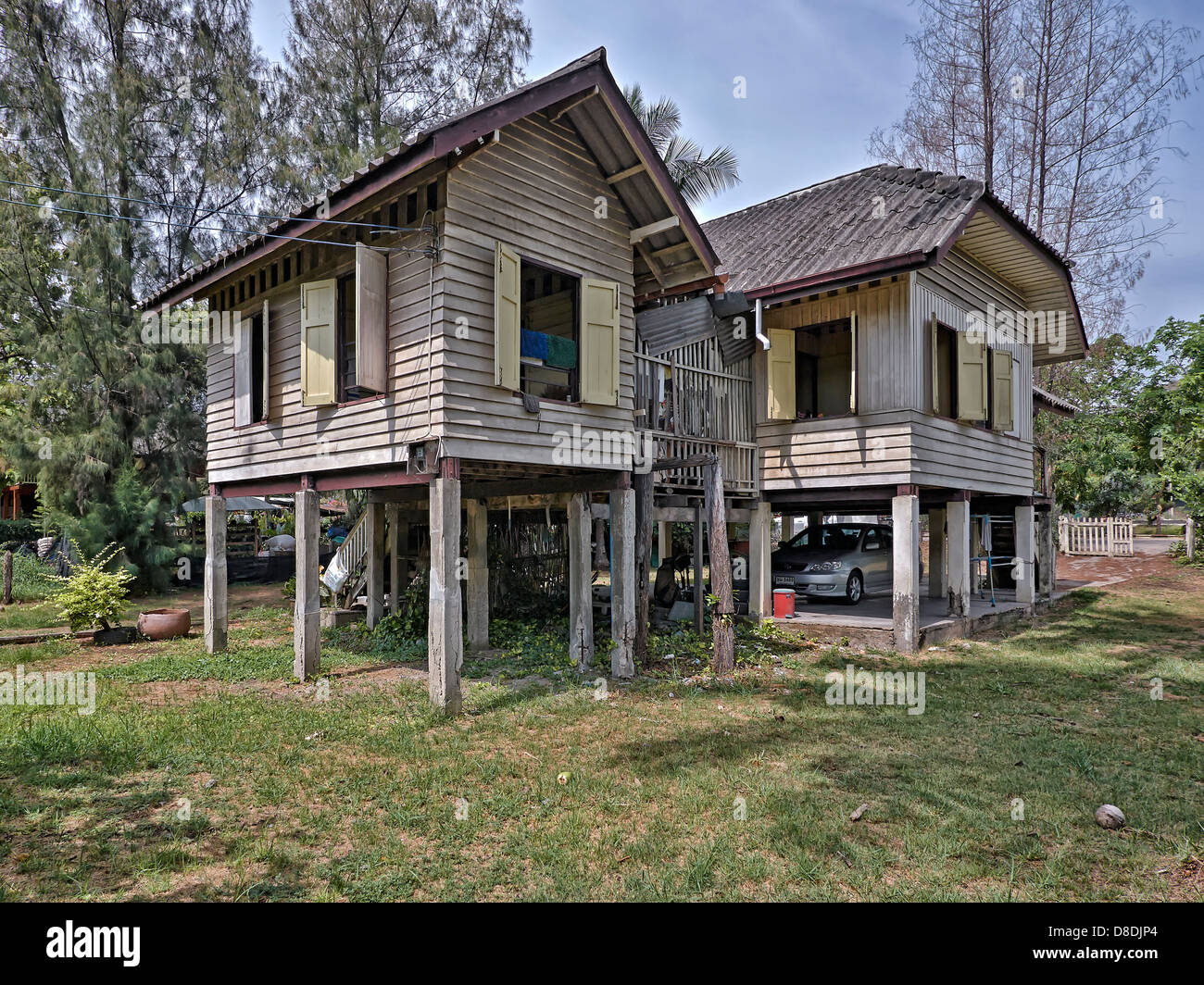 Tailandese tradizionale casa in legno su palafitte con auto parcheggiate al di sotto. Thailandia SUDEST ASIATICO Foto Stock