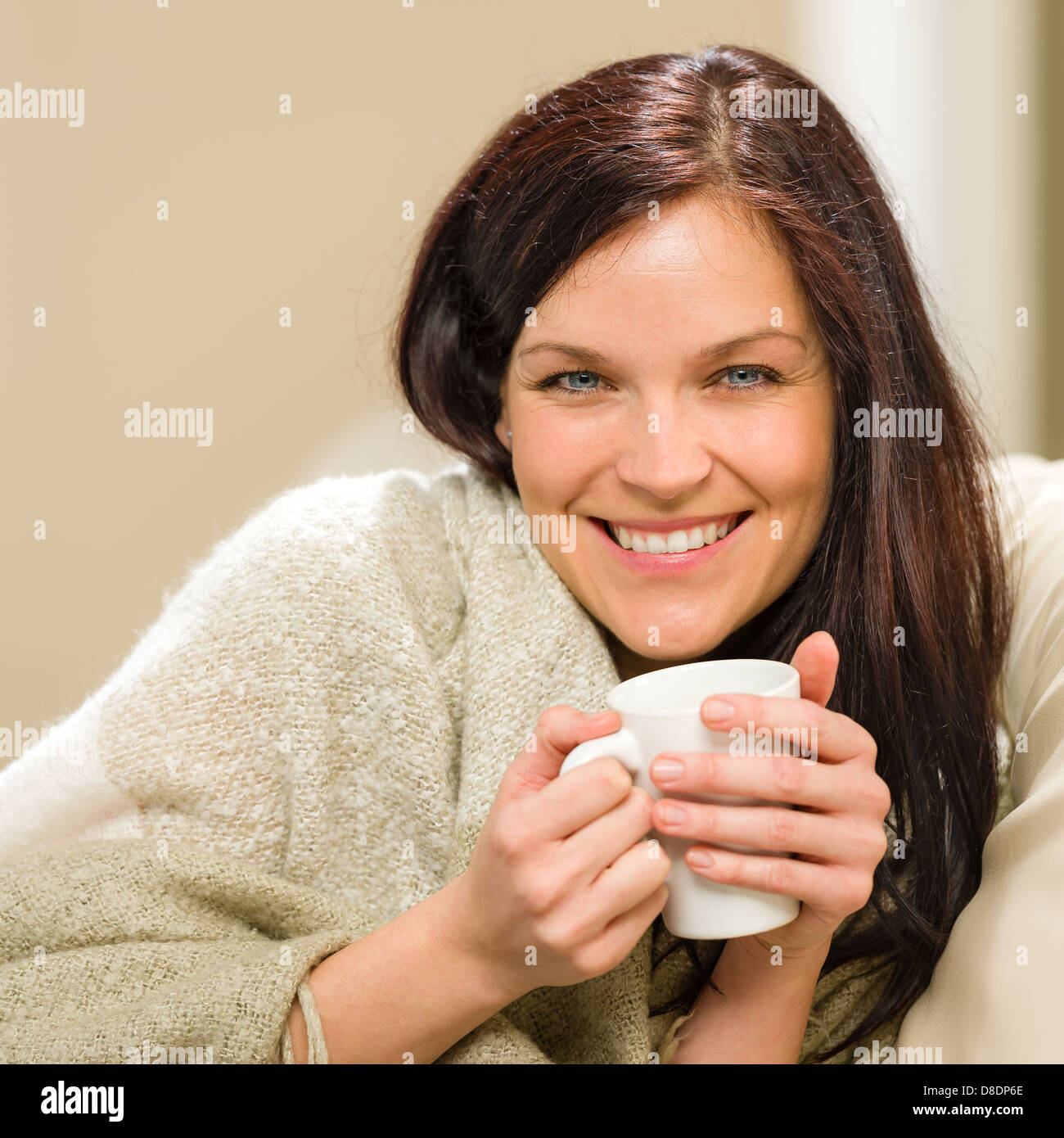 Ritratto di donna allegra bere bevande calde a casa Foto Stock