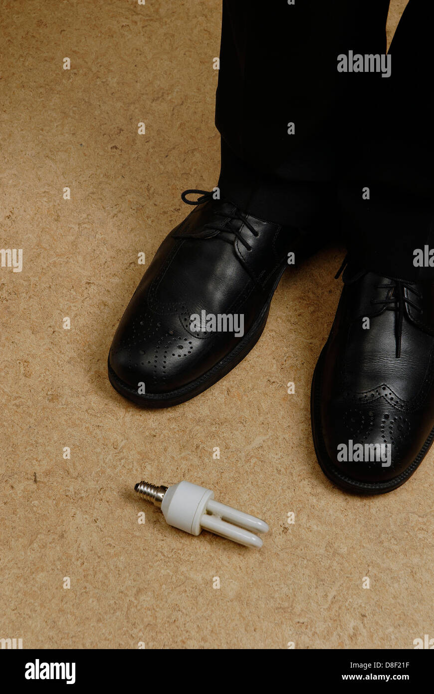 L uomo è in piedi di fronte ad una lampada a risparmio Foto Stock