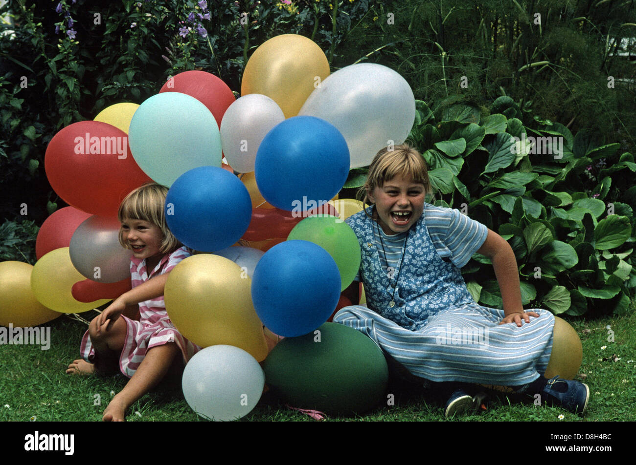Due giovani ragazze a una festa in giardino con palloncini Foto Stock