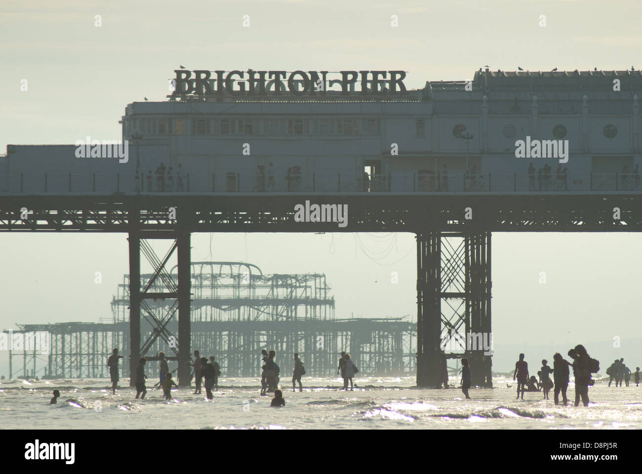Un tardo pomeriggio vista estiva di persone della bassa marea presso la spiaggia di Brighton. Foto Stock