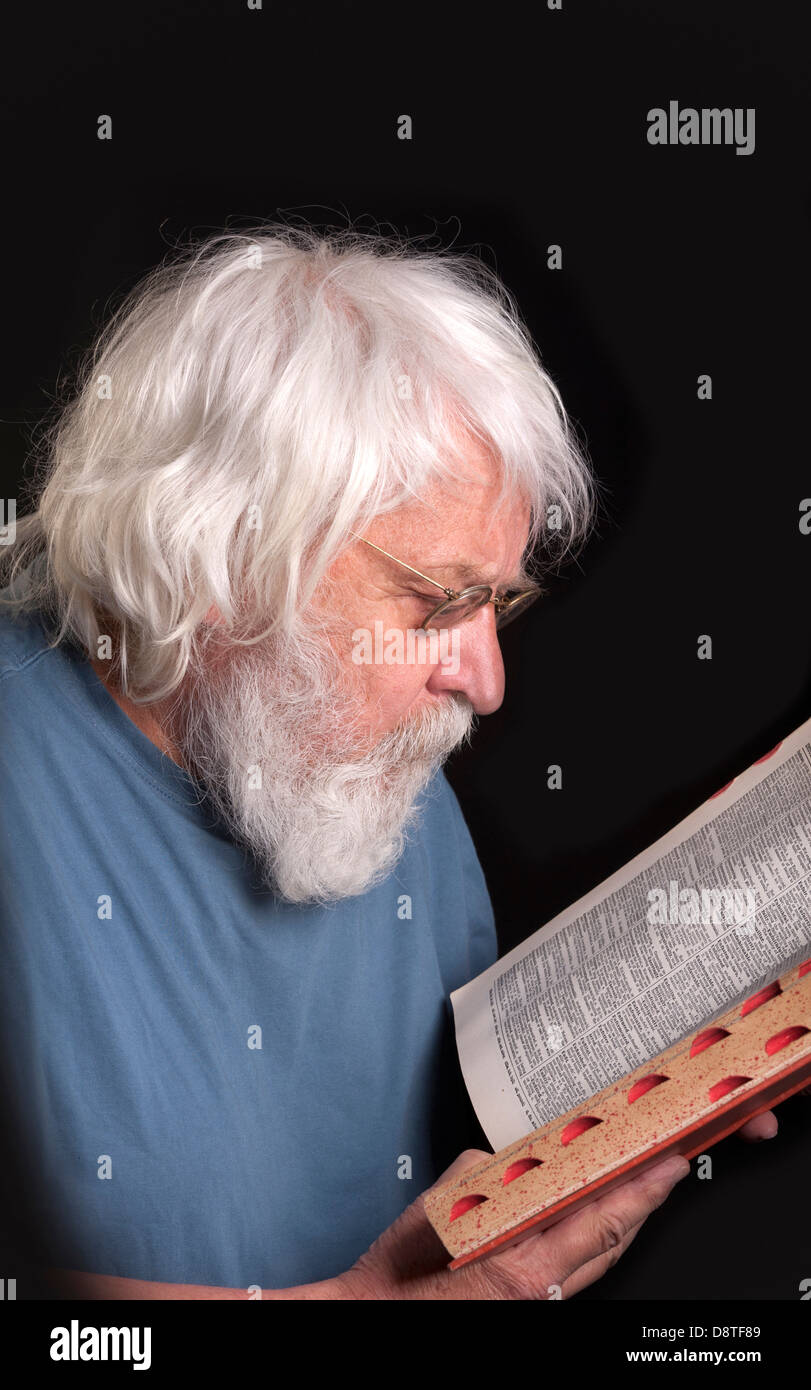Uomo anziano la lettura di un libro, scienziato e Maestro con la barba e occhiali di protezione Foto Stock