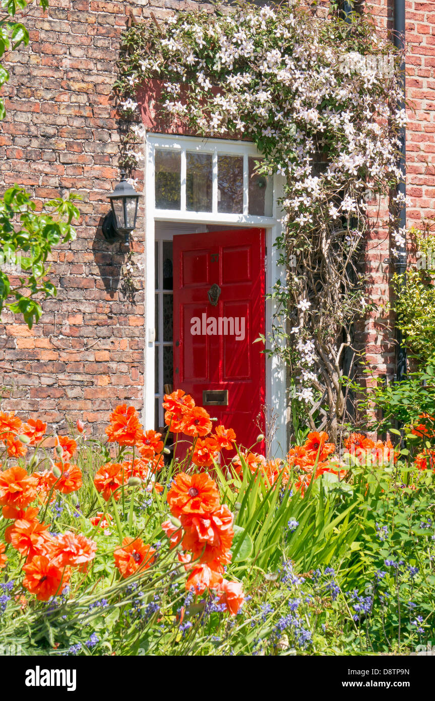 Accattivante display floreale attorno ad una porta entro Whitburn Village, North East England Regno Unito Foto Stock