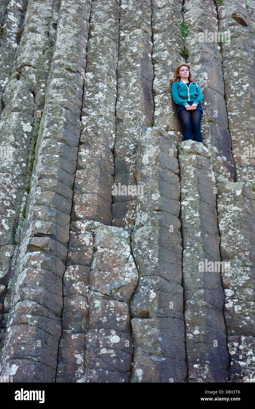 Ragazza adolescente da soli isolati su Giants causeway Foto Stock